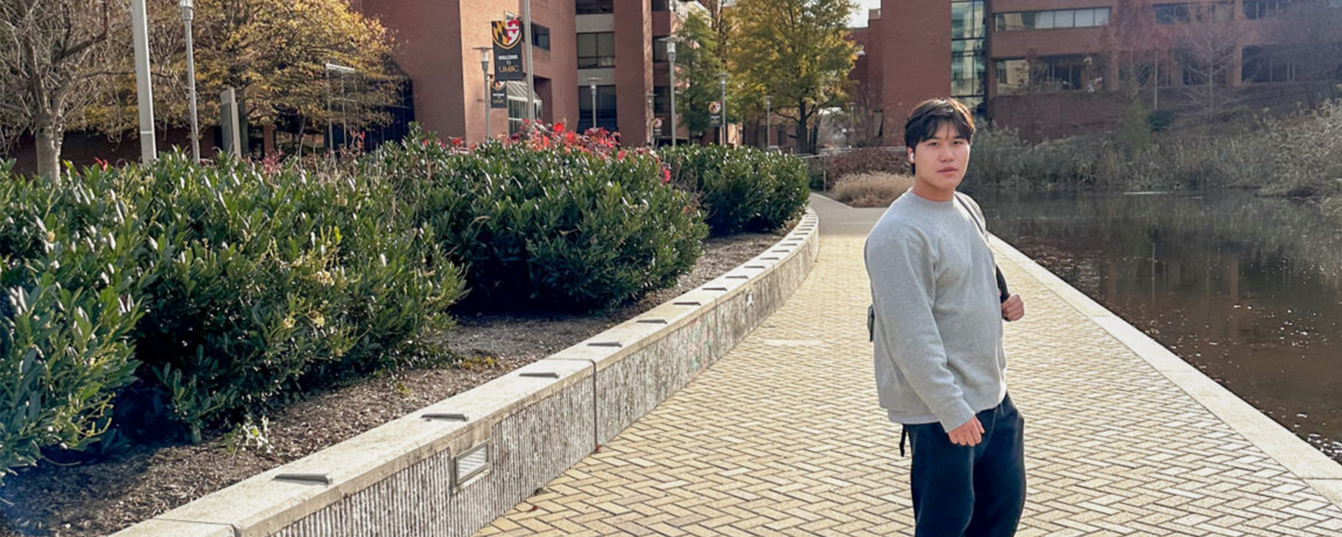 Garvey poses near Library Pond on UMBC's main campus. Photo courtesy of Chu.