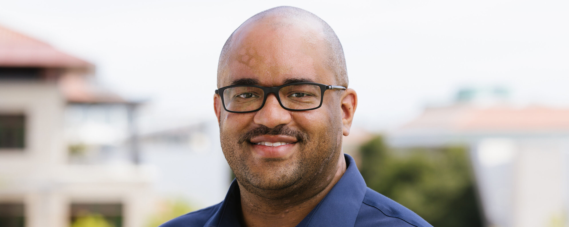 Smiling man looks at camera